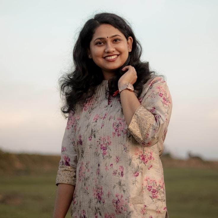 Lena Sharma, Lead Design Curator at Ridge Field Quartz, reviewing corporate floral arrangements